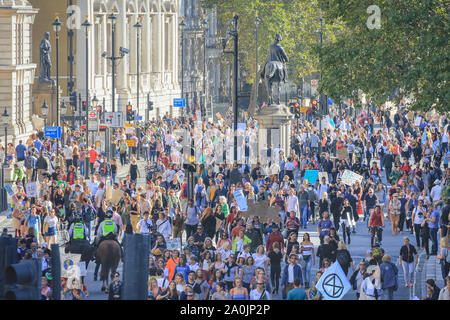 Westminster, London, UK, 20th Sep 2019. As the afternoon progresses, protesters make their way down Whitehall, and towards Trafalgar Square. Tens of thousands of children, young people and adults protest for climate action and against the causes of climate change in the British capital. Many similar protests take place in cities around the world in a day of global climate action.