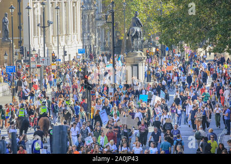 Westminster, London, UK, 20th Sep 2019. As the afternoon progresses, protesters make their way down Whitehall, and towards Trafalgar Square. Tens of thousands of children, young people and adults protest for climate action and against the causes of climate change in the British capital. Many similar protests take place in cities around the world in a day of global climate action.