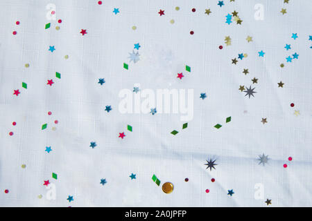 Festive colorfull stars of confetti on a white background . star shaped golden confetti on white background. stars in the form of confetti on white Stock Photo