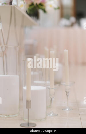 Stylish white candles in elegant glass candlesticks on a white background Stock Photo