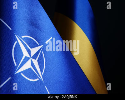 NATO and Ukraine flags as symbol of cooperation. Stock Photo