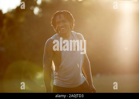 African-American man laughing in late afternoon sunlight Stock Photo