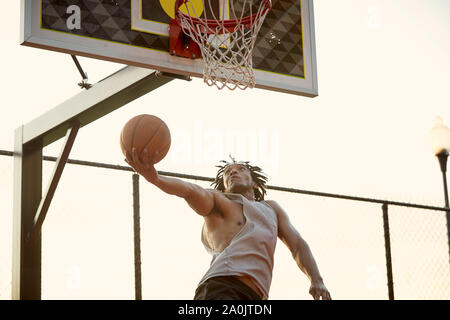 African-American man playing basketball outdoors Stock Photo