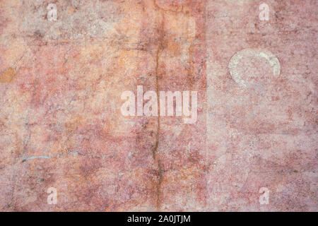 Antique, medieval pink plaster wall surface. Very old colorful wall texture with a crack. Abstract pink orange background. Stock Photo