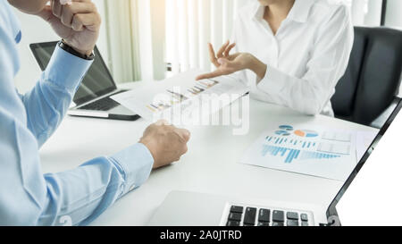 Team work process. young business managers crew working with new startup project. laptop on wood table, typing keyboard, texting message, analyze grap Stock Photo