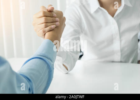 two clasped hands of businessmen. Stock Photo
