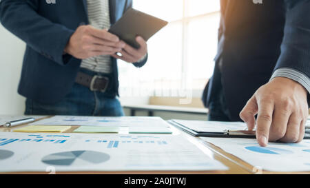 Team work process. young business managers crew working with new startup project. laptop on wood table, typing keyboard, texting message, analyze grap Stock Photo