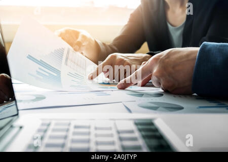 Team work process. young business managers crew working with new startup project. labtop on wood table, typing keyboard, texting message, analyze grap Stock Photo