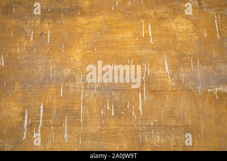 Grunge vintage wall.  Very old paint background with plaster stains. Visible brush marks, retro style. Weathered surface. Dirty wall texture. Stock Photo