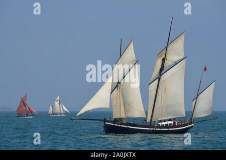 The Three Masted lugger Grayhound in the 2016 Brixham Heritage Regatta.  In the distance is the gaff cutter Golden Vanity and the Looe lugger Iris. Stock Photo