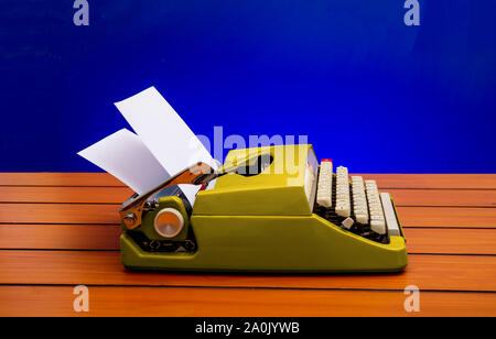 Old manual typewriter with white paper on wooden table, copy space banner Stock Photo