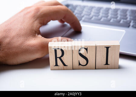 Man Working On Laptop With Repetitive Strain Injury Syndrome Letters Stock Photo