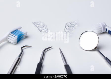 Dental Instruments And Clear Aligner On White Background Stock Photo
