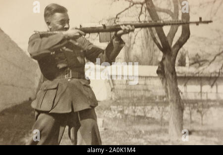 German soldier shoots with a gun. 1940s. Stock Photo