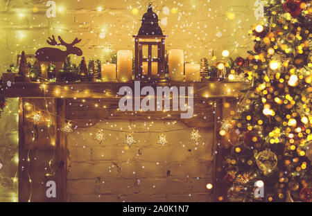 Magical festive composition, decorated fireplace with wooden mantelpiece fire surround, lit up Christmas tree with baubles, stars, lights, lantern and candles, bokeh, toned, selective focus Stock Photo