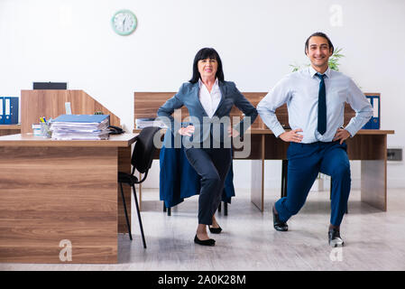 The two employees doing sport exercises in the office Stock Photo