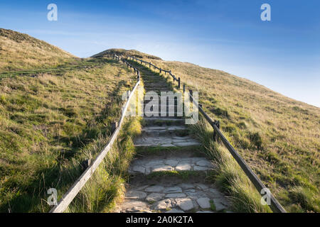 Stone steps leading up hill, journey concept of one step at a time Stock Photo