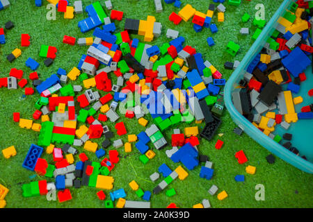Colored toy bricks with place on green ground very messy. High resolution image gallery. Stock Photo