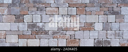 Stone wall made of different square natural stones Stock Photo