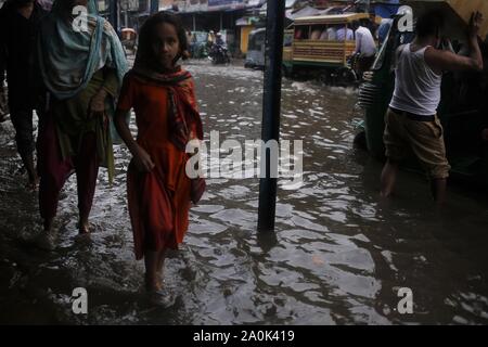 Dhaka, Bangladesh. 20th Sep, 2019. A girl reacts to the camera as she passes waterlogging after a heavy rain on a street near Gulistan. Credit: MD Mehedi Hasan/ZUMA Wire/Alamy Live News Stock Photo