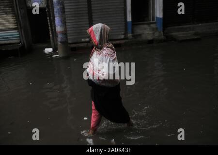Dhaka, Bangladesh. 20th Sep, 2019. A pedestrian passes waterlogging after a heavy rain on a street near old Dhaka. Credit: MD Mehedi Hasan/ZUMA Wire/Alamy Live News Stock Photo
