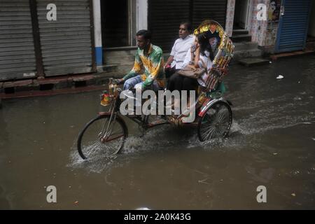 Dhaka, Bangladesh. 20th Sep, 2019. A rickshaw puller takes passenger as passes waterlogging after a heavy rain on a street near old Dhaka. Credit: MD Mehedi Hasan/ZUMA Wire/Alamy Live News Stock Photo