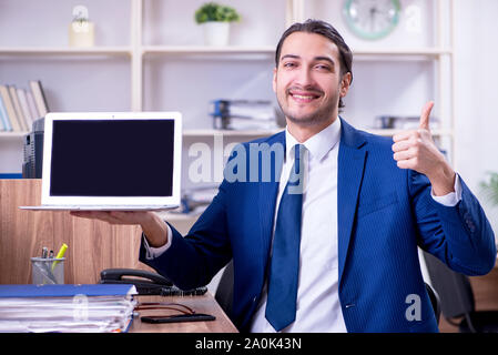 The young handsome businessman working in the office Stock Photo