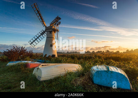 Sunrise colours on Thurne MIll on the Norfolk Broads in the UK Stock Photo