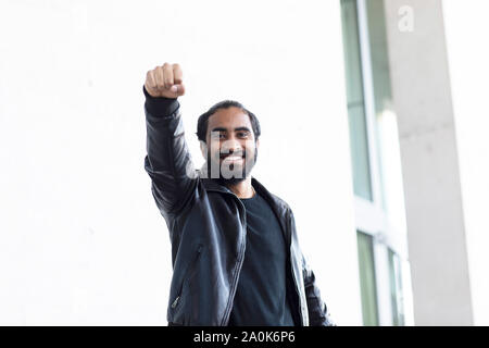 young man as with superman arm before a building Stock Photo