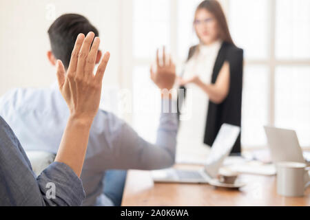 Business people raising there hand up at a meeting conference to answer a question and presenting there opinoin. Stock Photo