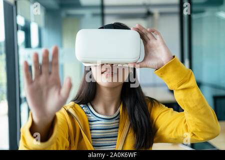 Young programmer or software developer with virtual reality glasses to testing 3D games and application. Technology and software development concept. Stock Photo