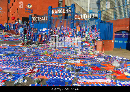 Glasgow, UK. 20th Sep, 2019. Tributes including flowers, scarves, football tops, cards and cakes have been left at the Broomloan Road and Copland Road gates of Ibrox Football Stadium, the home of Glasgow Rangers in respect for FERNANDO RICKSEN, the Dutch international footballer who played for Rangers and who died of Motor Neuron Disease (MND) on 18th September 2019, aged 43. Credit: Findlay/Alamy Live News Stock Photo