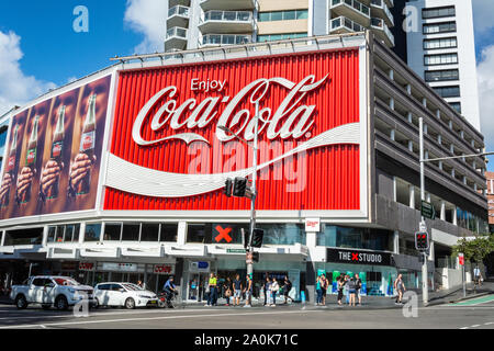 Sydney, Australia - March 10, 2017. The Coca-Cola Billboard in Kings Cross, Sydney, with commercial properties and people, at daytime. Stock Photo