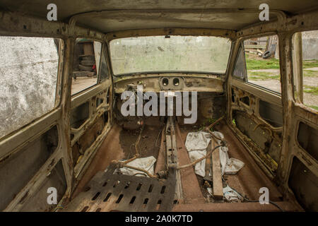 Interior of wrecked car inside an abandoned factory in Brazil Stock Photo