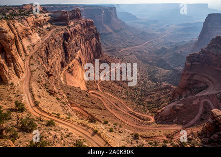 A jeep road winds down the side of a canyon in Canyonlands Natl Park. Stock Photo