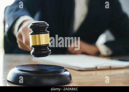 Justice and lawfirm concept. Male lawyer in the office with brass scale. Stock Photo