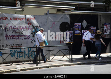 Athens Greece People Walking by Derelict Building with Graffiti on Stadiou Street Stock Photo