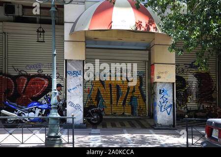 Athens Greece Stadiou Street Shutters down on Derelict Building with Graffiti Stock Photo