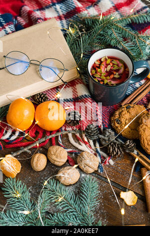 Hot tea with lemon and lingonberry leaves and other food and symbols of xmas Stock Photo