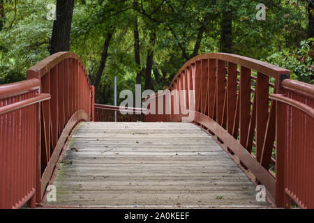Pretty red bridge with tree canopy Stock Photo