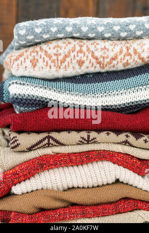 Knitted sweaters of various colors with ornaments ready for autumn and winter Stock Photo