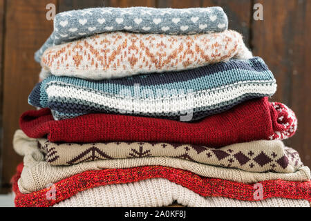 Warm cotton and woolen sweaters on top of each other prepared for cold season Stock Photo
