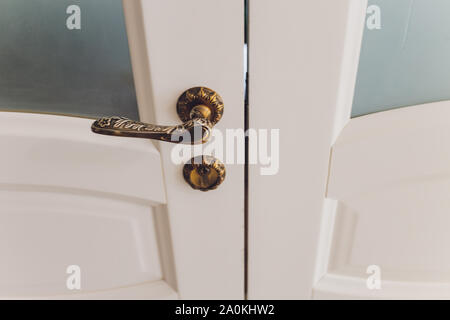 Antique interior doorknob on an old wooden door Stock Photo