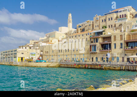 Tel-Aviv, Israel - September 19, 2019: Scene of the historic Jaffa port, with Saint Peter Church tower, locals and visitors. Now part of Tel-Aviv-Yafo