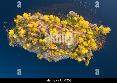 Small idyllic forest covered island top view. Aerial landscape Stock Photo