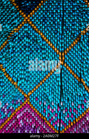 Abstract background of colorful small vertical plastic or wooden rods forming a textured geometric pattern with blue orange and purple hues Stock Photo