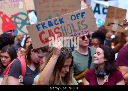 New York, NY. September 20, 2019. A woman holds a sign 'Frack off, Gasholes' in protest of fracking at the youth-led NYC Climate Strike. Tens of thousands of people, students attended the march and rally down Broadway to Battery Park with Greta Thunberg as a participant and featured guest. Stock Photo