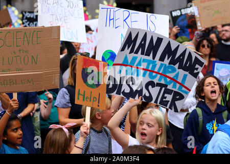 New York, NY. September 20, 2019. Kids hold signs 'Man Made Disaster' at the youth-led NYC Climate Strike. Tens of thousands of people, students attended the march and rally down Broadway to Battery Park with Greta Thunberg as a participant and featured guest. Stock Photo