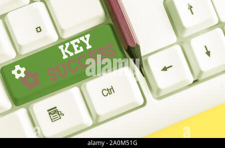 Conceptual hand writing showing Key Success. Concept meaning generally three to five areas that company may focus on White pc keyboard with note paper Stock Photo