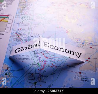 Close up of global economy tag on a world map Stock Photo